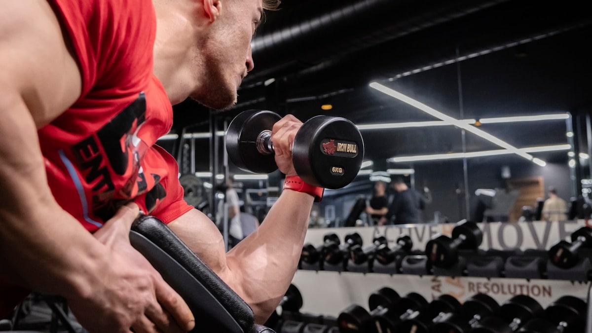 a man lifting a dumbbell in a gym